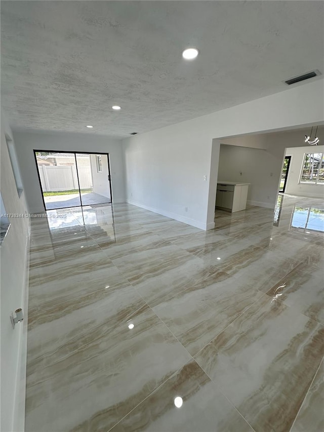 empty room featuring a textured ceiling