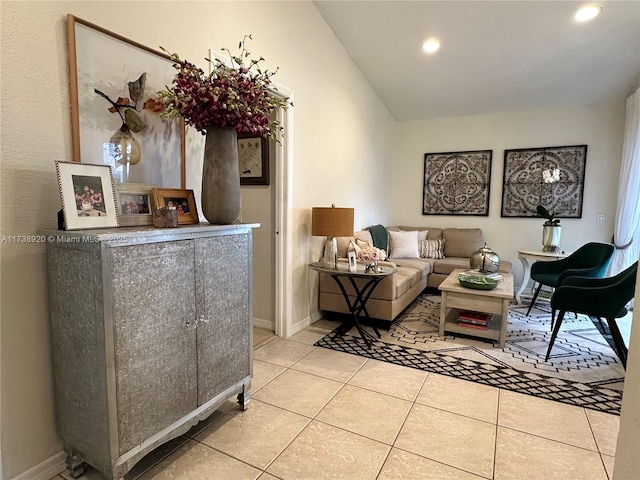 tiled living room featuring vaulted ceiling