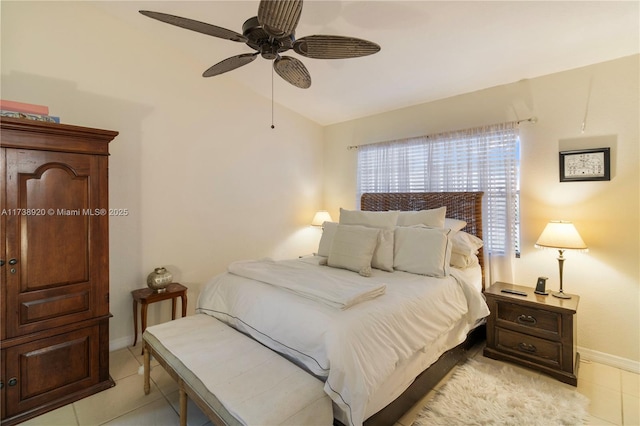 tiled bedroom with ceiling fan and vaulted ceiling