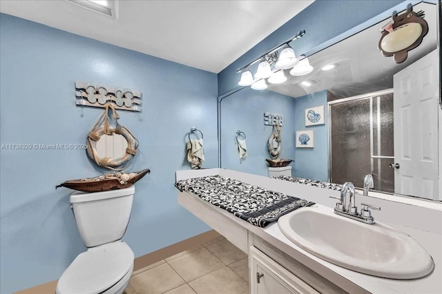 bathroom with toilet, vanity, tile patterned floors, and a shower with shower door