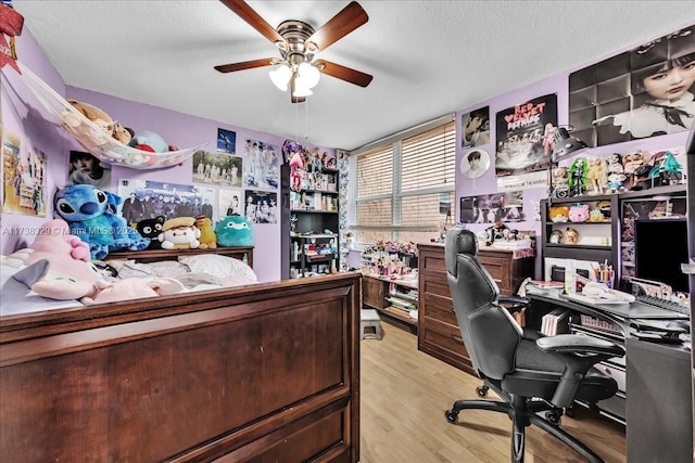 office featuring ceiling fan, a textured ceiling, and light hardwood / wood-style floors