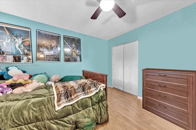 bedroom featuring a closet, ceiling fan, and light hardwood / wood-style flooring