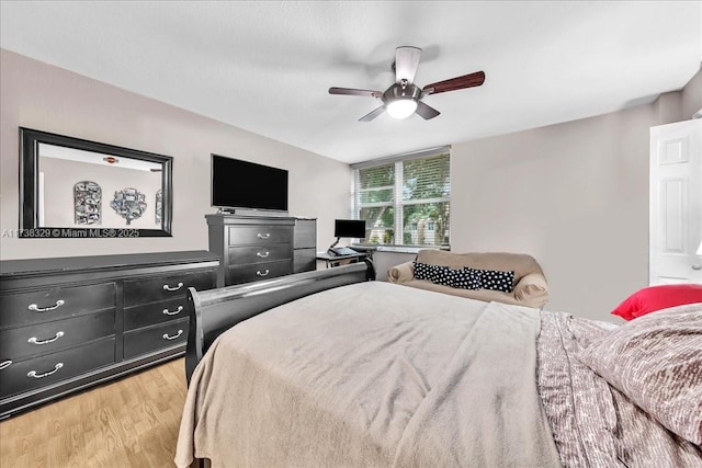 bedroom with light hardwood / wood-style flooring and ceiling fan