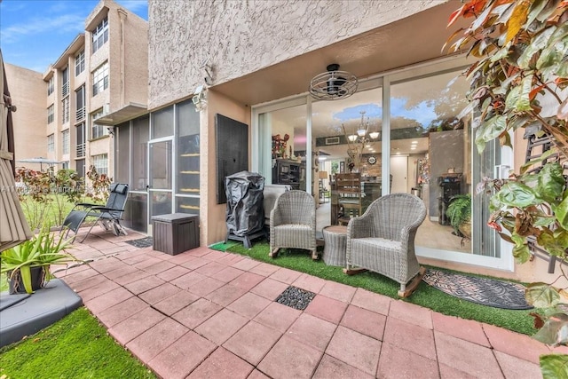 view of patio featuring a sunroom