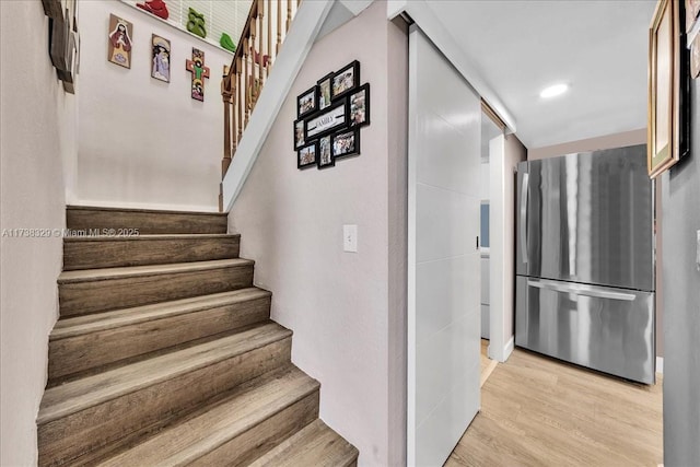 stairs featuring hardwood / wood-style floors