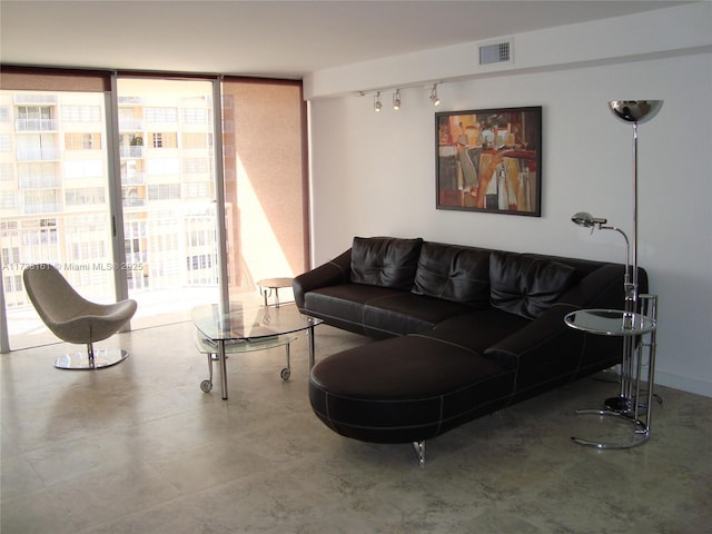 living room featuring track lighting and floor to ceiling windows