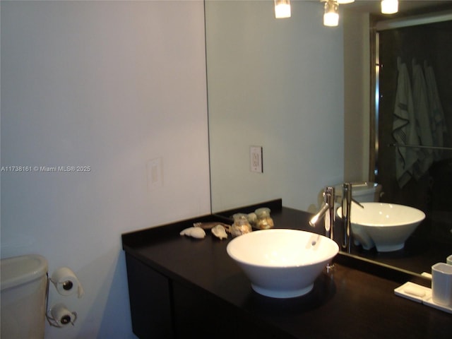 bathroom featuring vanity and toilet