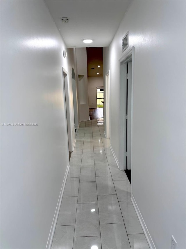 corridor with light tile patterned flooring