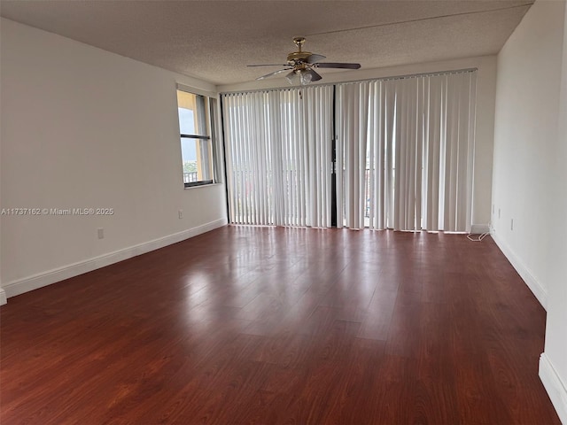 spare room featuring ceiling fan, dark hardwood / wood-style floors, and a textured ceiling