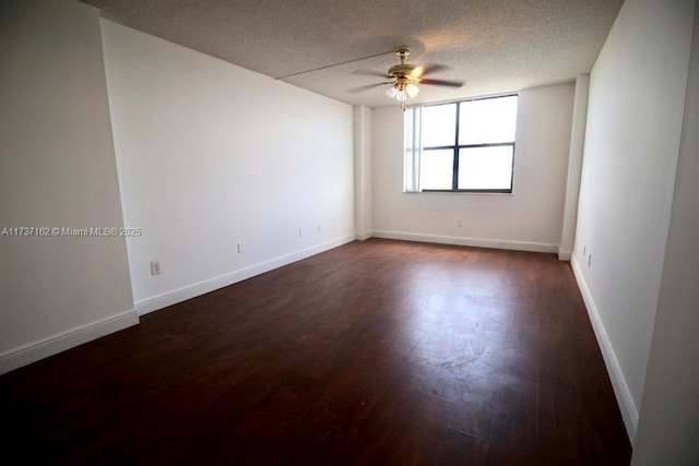 spare room with ceiling fan, dark hardwood / wood-style floors, and a textured ceiling