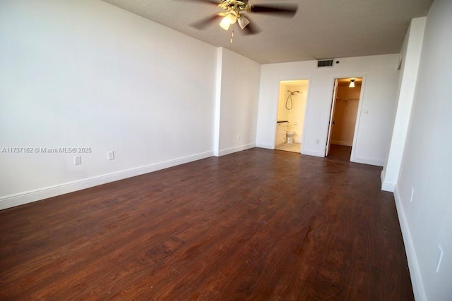 empty room featuring dark hardwood / wood-style flooring and ceiling fan