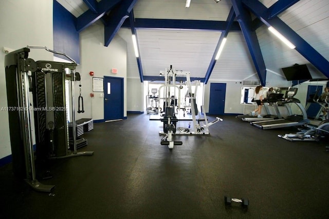 workout area featuring high vaulted ceiling