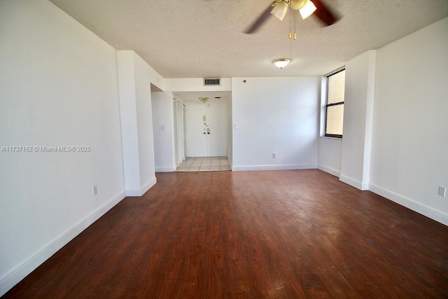 unfurnished room with hardwood / wood-style flooring, ceiling fan, and a textured ceiling