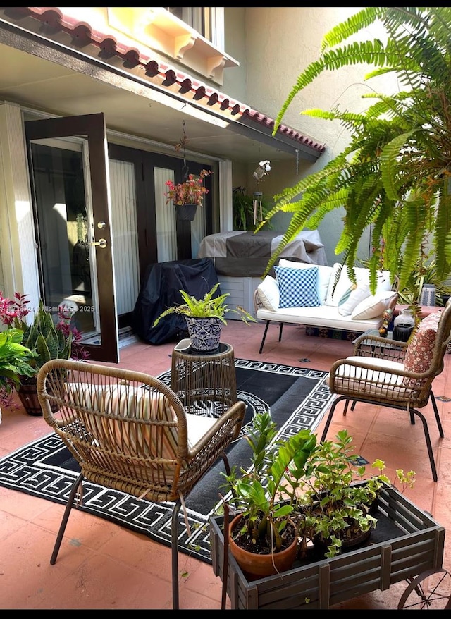 balcony with an outdoor living space, a patio, and a grill