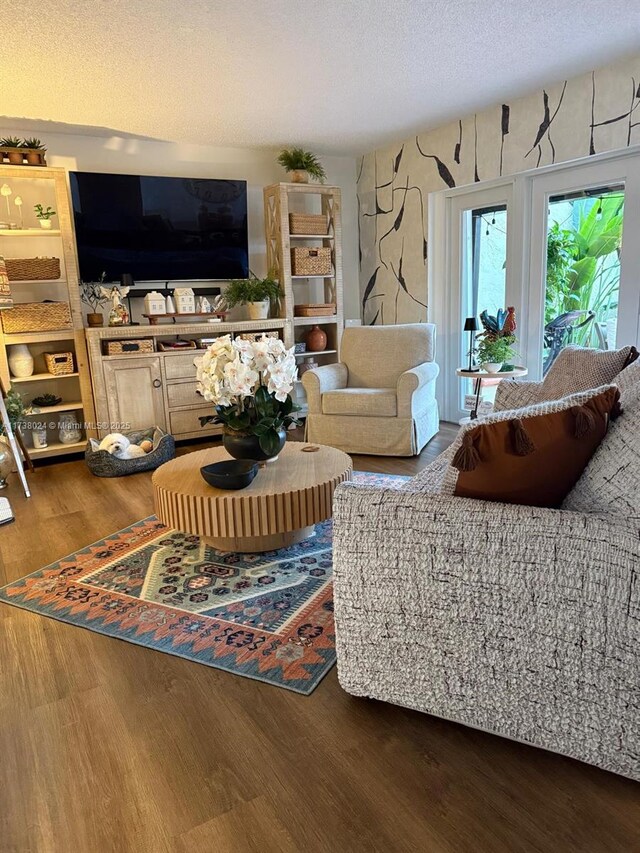 living room featuring hardwood / wood-style floors and a textured ceiling