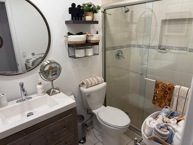 bathroom featuring a shower with door, vanity, and toilet