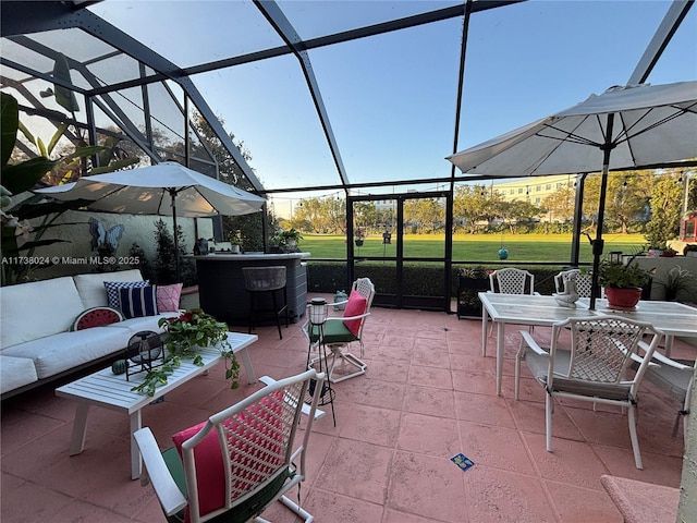 view of patio / terrace featuring an outdoor living space and glass enclosure