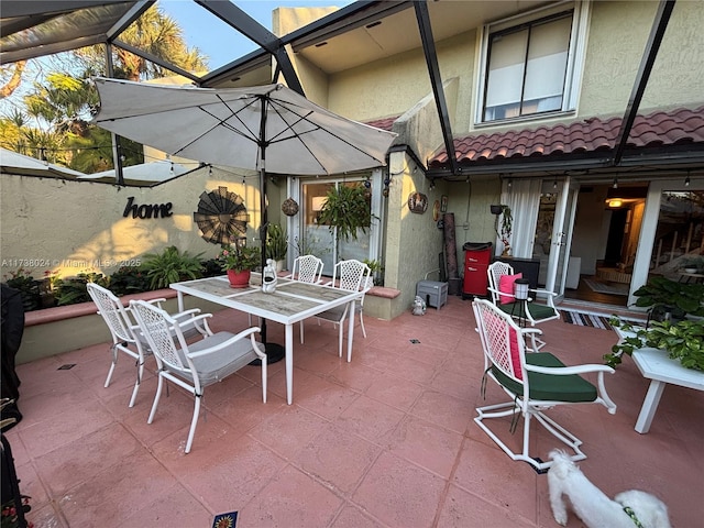 view of patio / terrace featuring glass enclosure