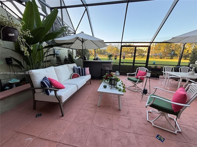 view of patio / terrace featuring outdoor lounge area, glass enclosure, and a jacuzzi