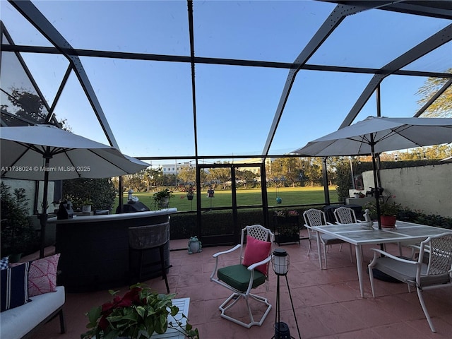 view of patio / terrace featuring glass enclosure