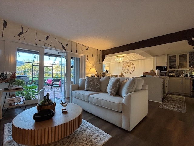 living room with dark wood-type flooring and a textured ceiling