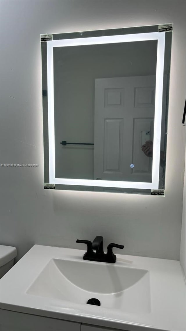 bathroom with vanity and toilet