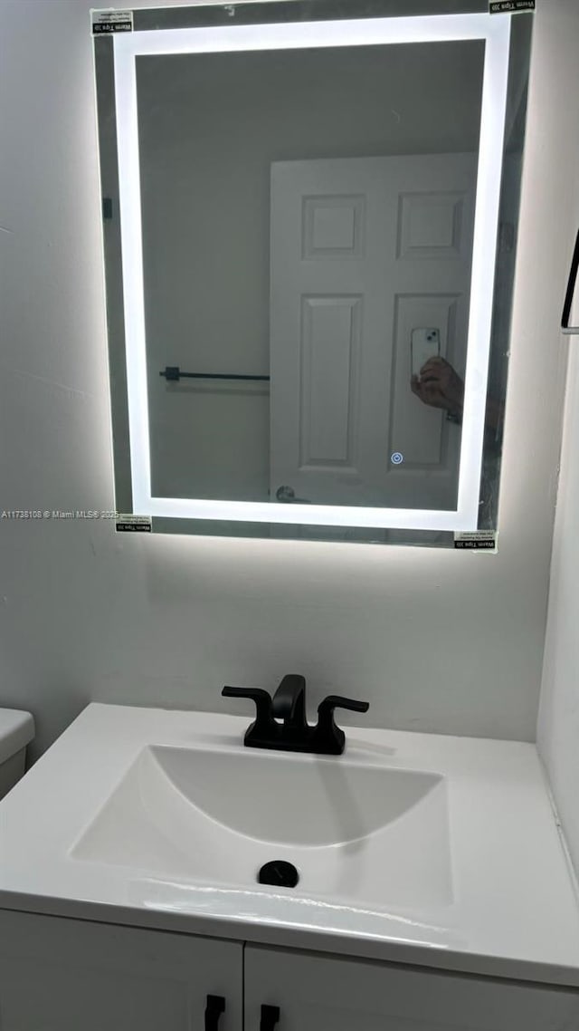 bathroom featuring vanity and toilet