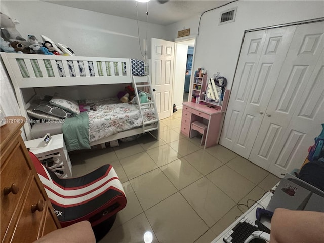 bedroom with a closet and light tile patterned flooring