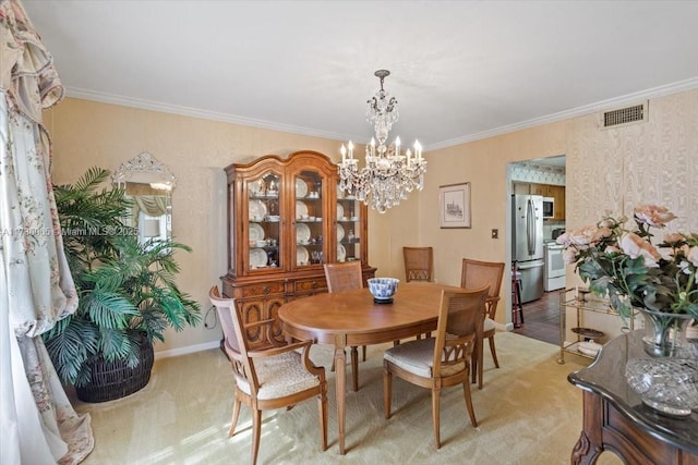 carpeted dining room featuring an inviting chandelier and crown molding