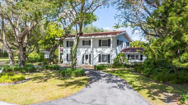 mediterranean / spanish-style house featuring a front lawn