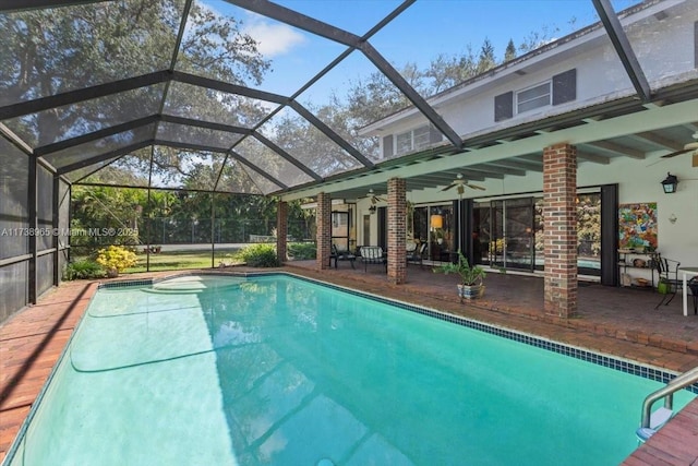 view of swimming pool with a lanai, ceiling fan, and a patio area