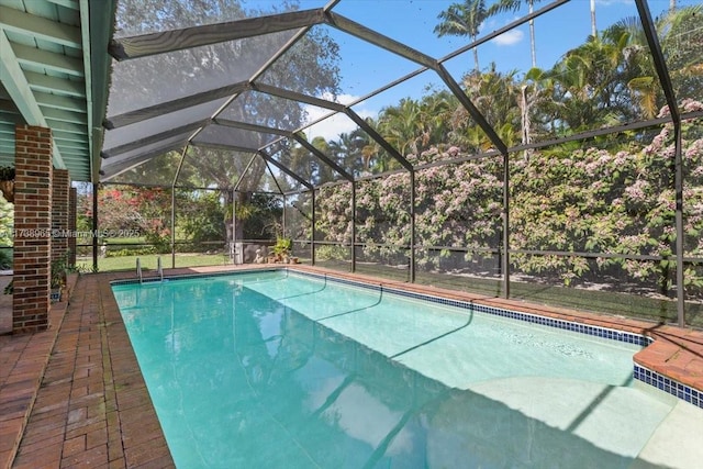 view of pool with a patio and glass enclosure