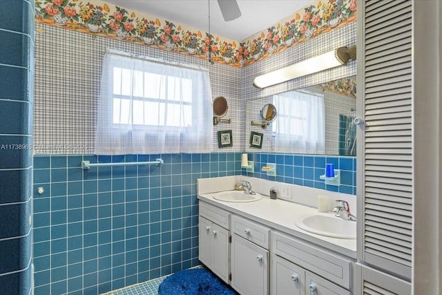 bathroom with tile walls, vanity, and ceiling fan