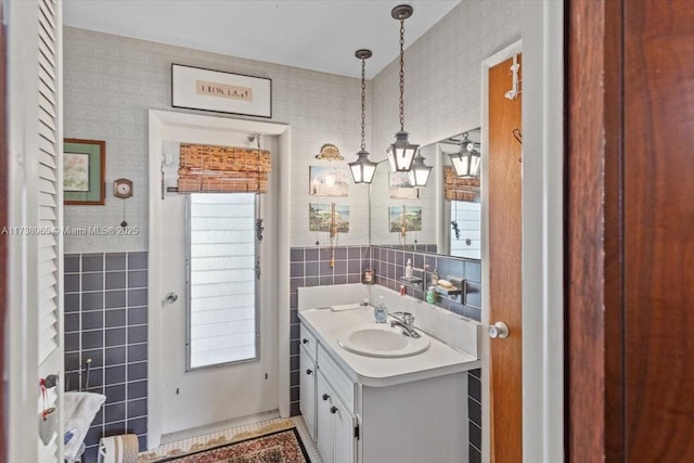 bathroom with tile walls and vanity