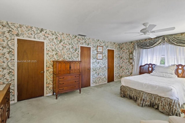 bedroom with ceiling fan and light carpet