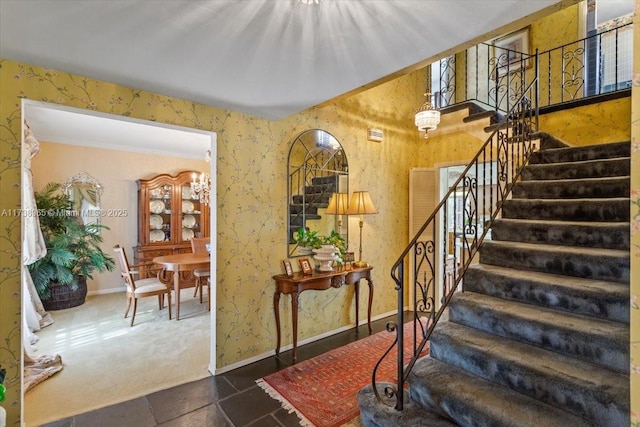 staircase with ornamental molding and carpet flooring