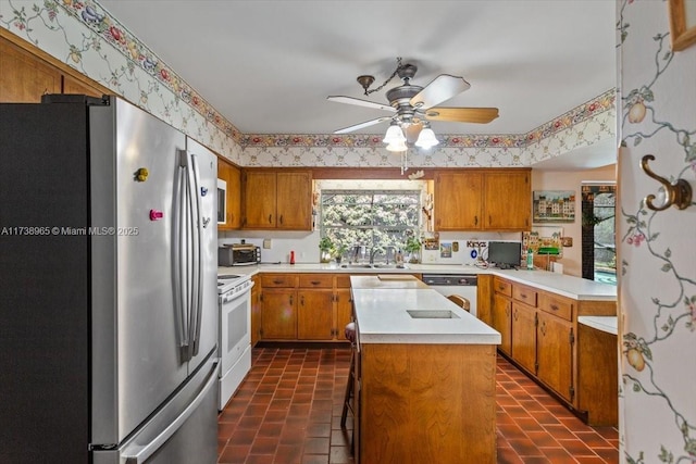 kitchen with ceiling fan, a center island, sink, and white appliances