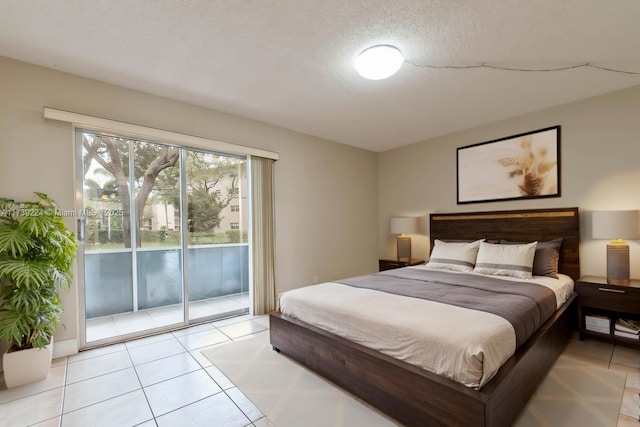 bedroom with a textured ceiling, access to outside, and light tile patterned flooring