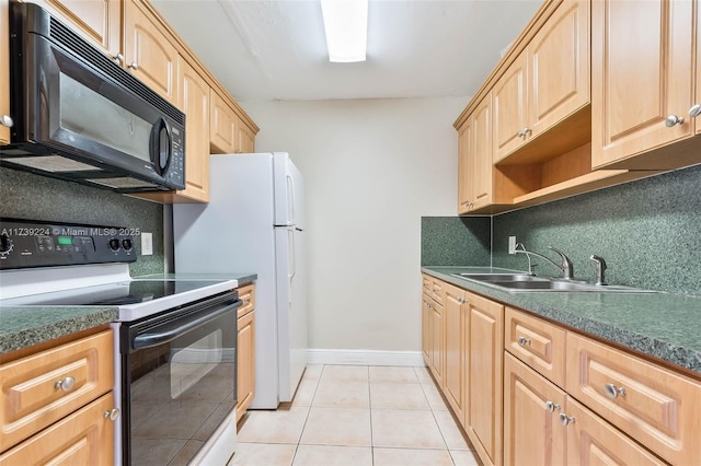 kitchen featuring black microwave, range with electric cooktop, a sink, tasteful backsplash, and dark countertops