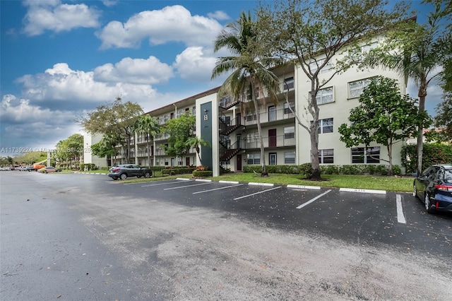 view of building exterior featuring uncovered parking