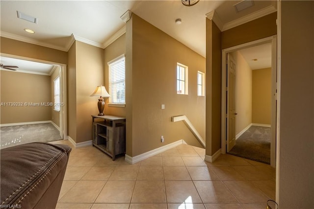 hall with light tile patterned flooring and ornamental molding