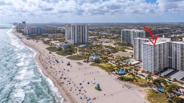 aerial view with a water view and a view of the beach