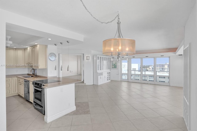 kitchen featuring sink, decorative light fixtures, kitchen peninsula, and appliances with stainless steel finishes