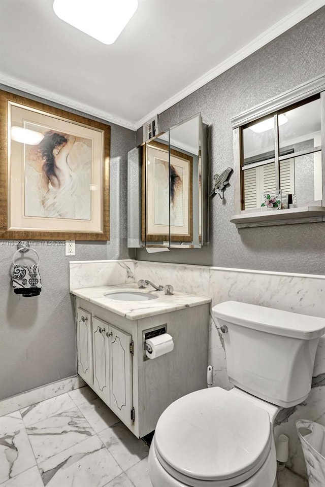 bathroom featuring crown molding, vanity, and toilet