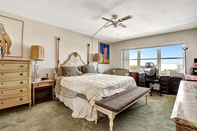 bedroom featuring ceiling fan, carpet floors, and a textured ceiling