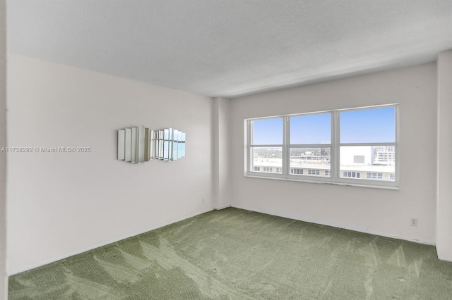 empty room with carpet and a textured ceiling