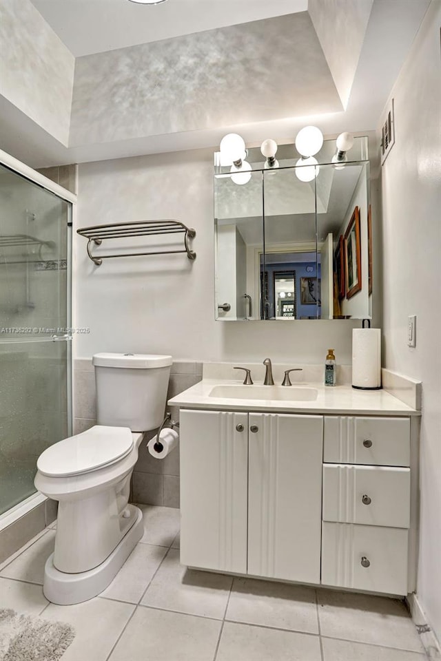 bathroom featuring vanity, an enclosed shower, tile patterned floors, and toilet