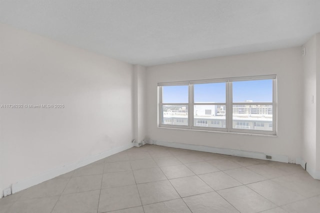 tiled spare room with a wealth of natural light