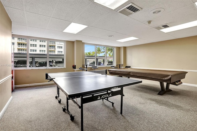 game room featuring a drop ceiling and carpet