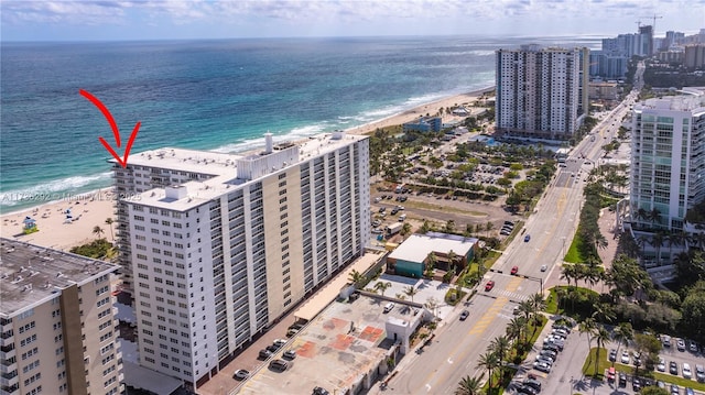 bird's eye view with a water view and a beach view